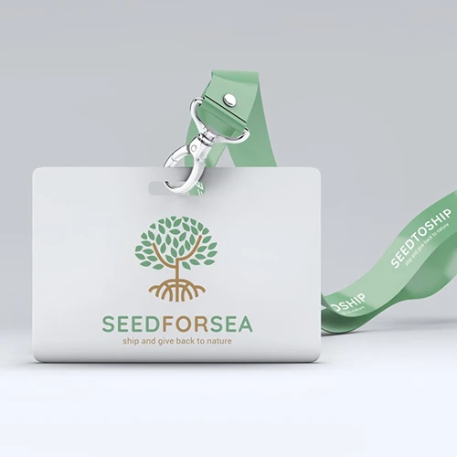 Insignia del evento Seed for Sea con logotipo de árbol estilizado verde y marrón y cordón verde marcado “SEEDTOSHIP”.